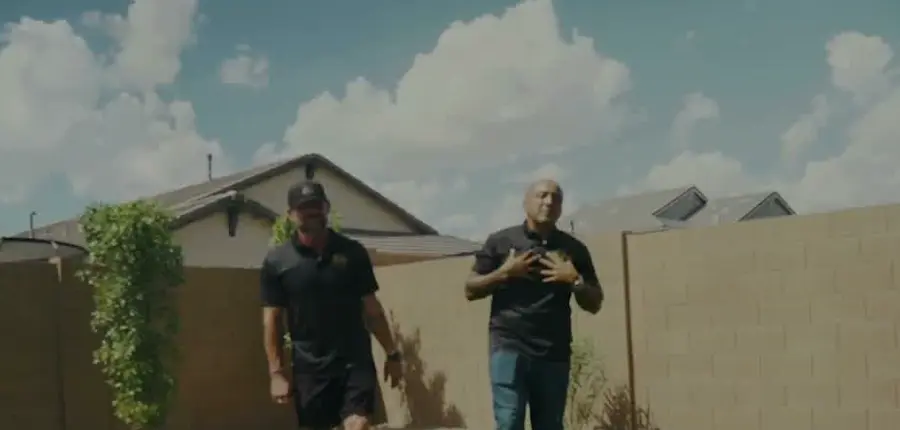 United Custom Landscapes and Pools owners walking a finished backyard